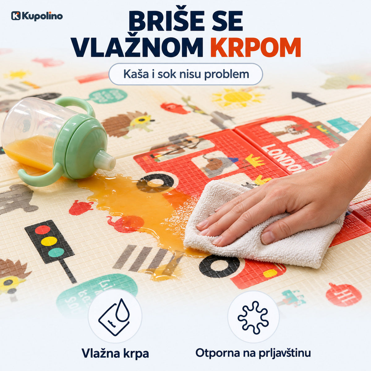 Ruka vlažnom krpom briše prosuti sok sa podloge za igru